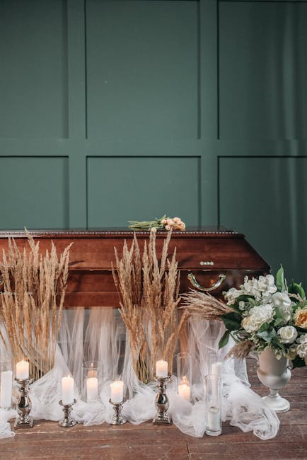 A floral arrangement featuring white and cream roses, along with greenery, is placed in a white ceramic vase on the right side of the image. The flowers are fresh, with soft petals and green leaves, a